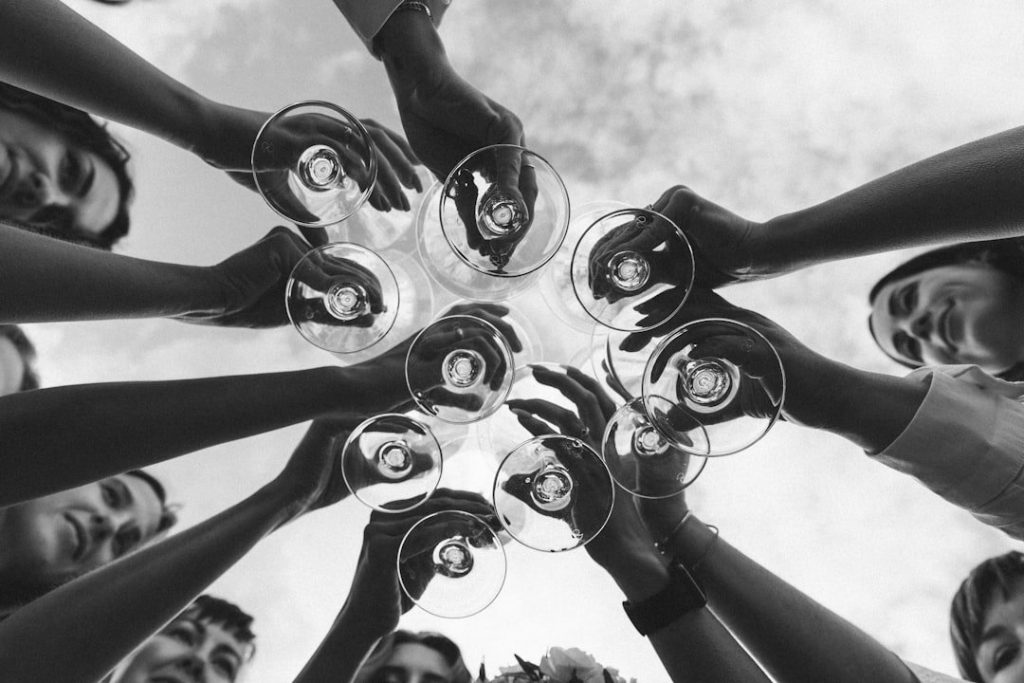 a group of people holding wine glasses